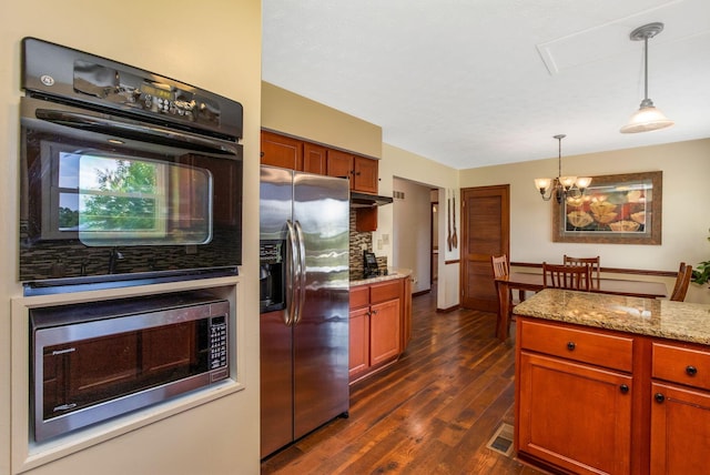 3251 Old Mill Rd NE, Lancaster, OH 43130 - kitchen featuring appliances with stainless steel finishes, a chandelier, dark wood-type flooring, pendant lighting, and light stone countertops
