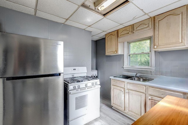 261 Superior St, Mansfield, OH 44902 - kitchen with freestanding refrigerator, white range with gas cooktop, light wood finished floors, a drop ceiling, and butcher block counters