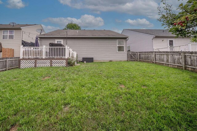 2621 Edencreek Ln, Columbus, OH 43207 - back of house with a fenced backyard, a wooden deck, and roof with shingles