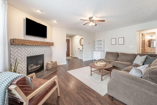 2621 Edencreek Ln, Columbus, OH 43207 - living room featuring a ceiling fan, a fireplace, dark wood-style flooring, a textured ceiling, and recessed lighting