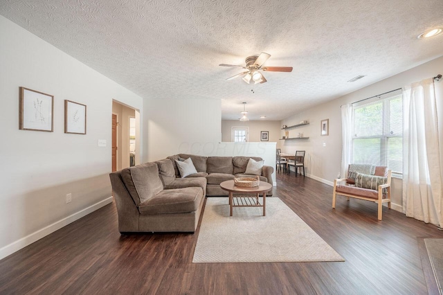 2621 Edencreek Ln, Columbus, OH 43207 - living area with dark wood-style floors, a ceiling fan, and a textured ceiling