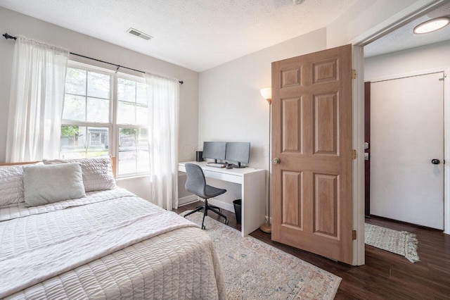 2621 Edencreek Ln, Columbus, OH 43207 - bedroom with wood finished floors, a textured ceiling, and a desk