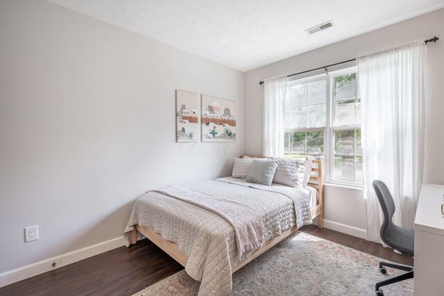 2621 Edencreek Ln, Columbus, OH 43207 - bedroom with wood finished floors, a textured ceiling, and a desk