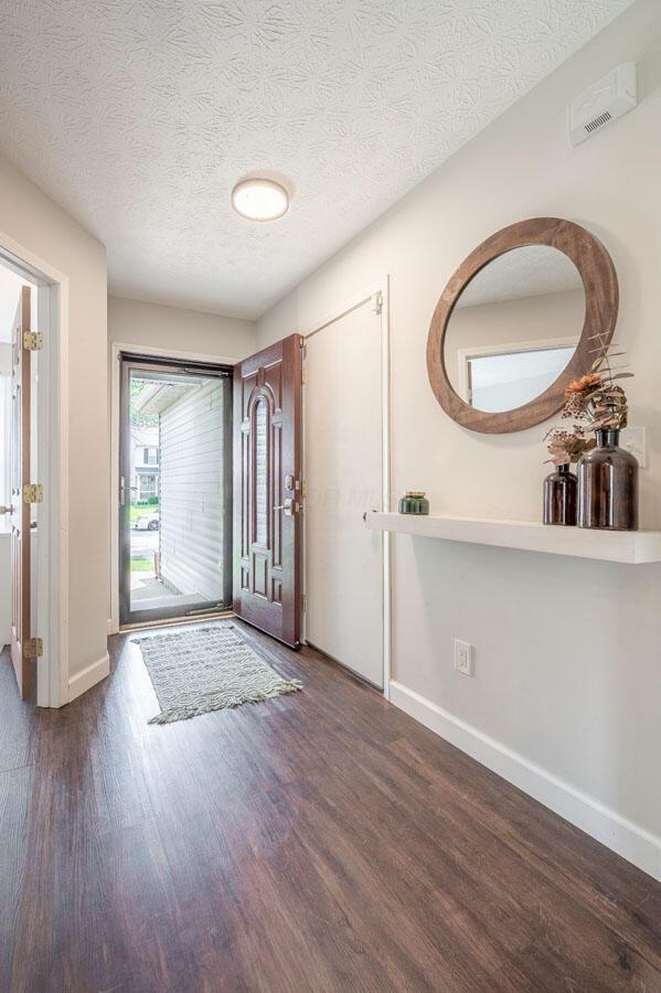 2621 Edencreek Ln, Columbus, OH 43207 - foyer featuring wood finished floors and a textured ceiling