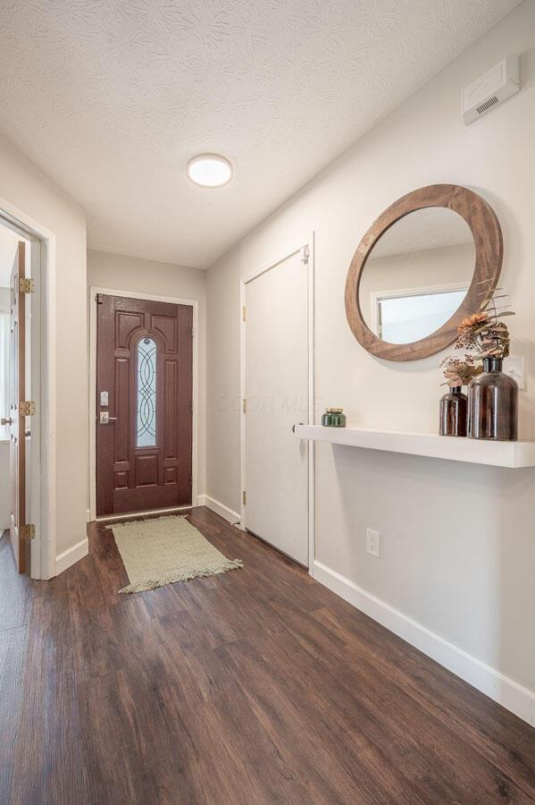 2621 Edencreek Ln, Columbus, OH 43207 - entryway with wood finished floors and a textured ceiling