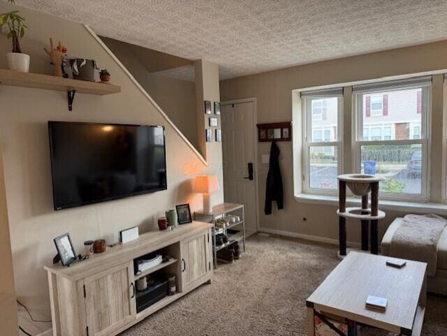 796 Cap Ln Unit 21C, Columbus, OH 43085 - carpeted living area with a textured ceiling and baseboards