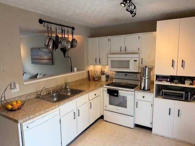 796 Cap Ln Unit 21C, Columbus, OH 43085 - kitchen featuring white appliances, a textured ceiling, light countertops, and white cabinets
