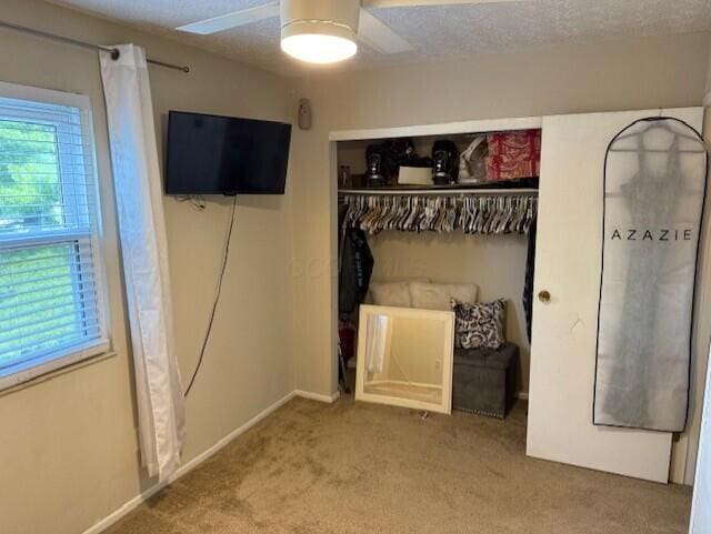 796 Cap Ln Unit 21C, Columbus, OH 43085 - unfurnished bedroom featuring carpet floors, a closet, a textured ceiling, and a ceiling fan