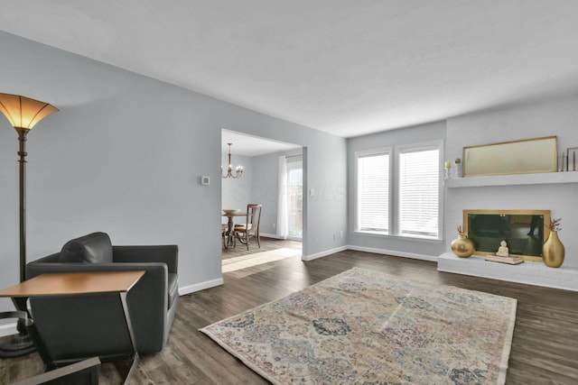 1533 Sandringham Ct, Columbus, OH 43220 - living room featuring a brick fireplace, a chandelier, and dark wood finished floors