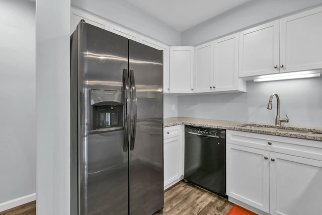 1533 Sandringham Ct, Columbus, OH 43220 - kitchen with stainless steel fridge, black dishwasher, white cabinets, and wood finished floors