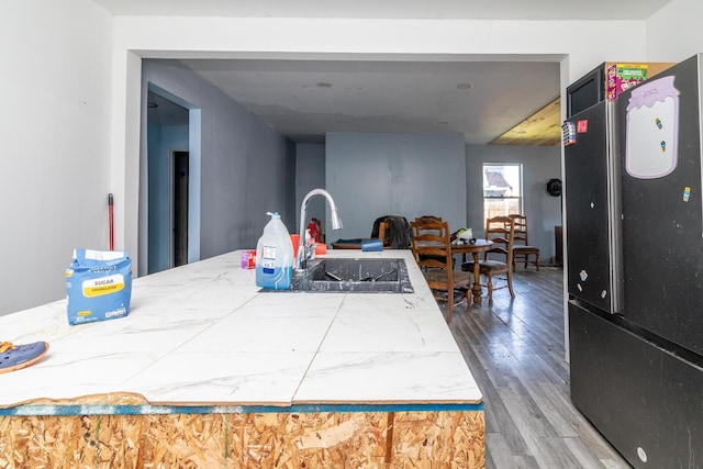 324 Quarry St, Marion, OH 43302 - kitchen featuring freestanding refrigerator, wood finished floors, light countertops, and open floor plan