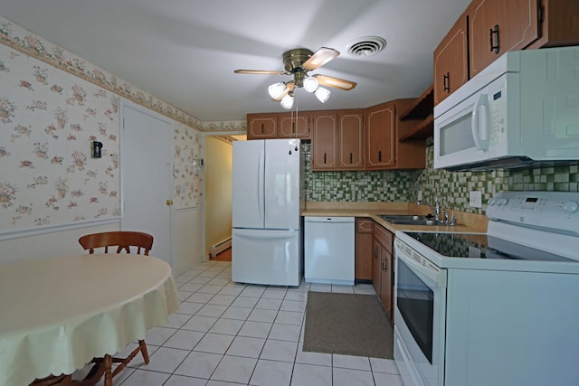 5278 Edgeview Rd, Columbus, OH 43207 - kitchen featuring white appliances, a ceiling fan, a baseboard heating unit, light tile patterned floors, and brown cabinets