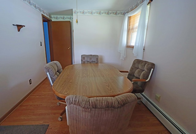5278 Edgeview Rd, Columbus, OH 43207 - dining room featuring a baseboard heating unit and wood finished floors