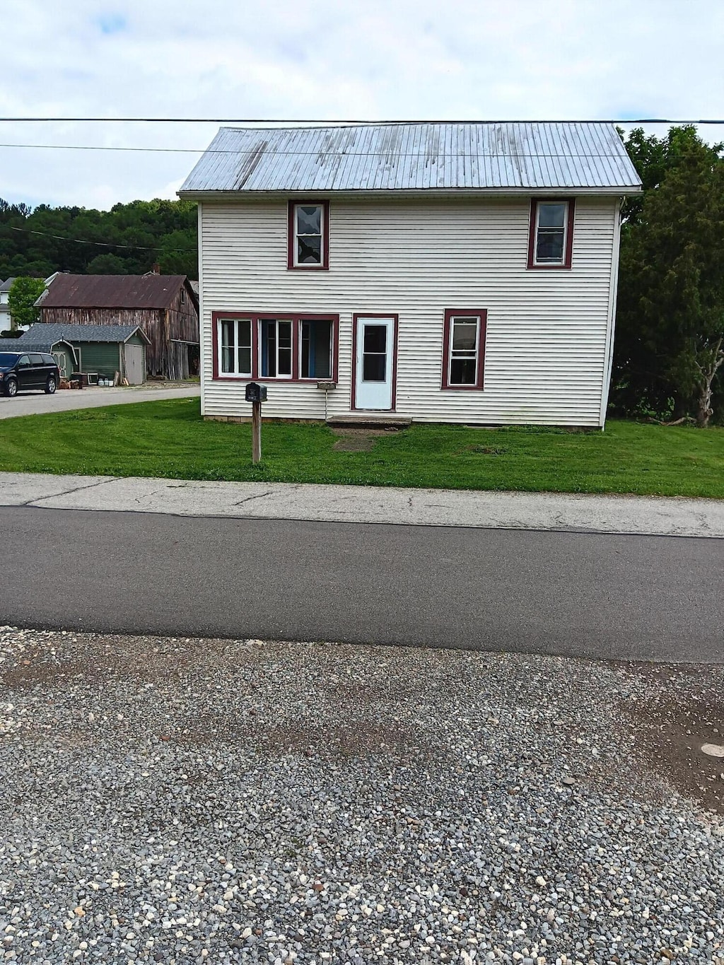 323 Galation St, Glenmont, OH 44628 - view of front of property with a front yard, a metal roof, and driveway
