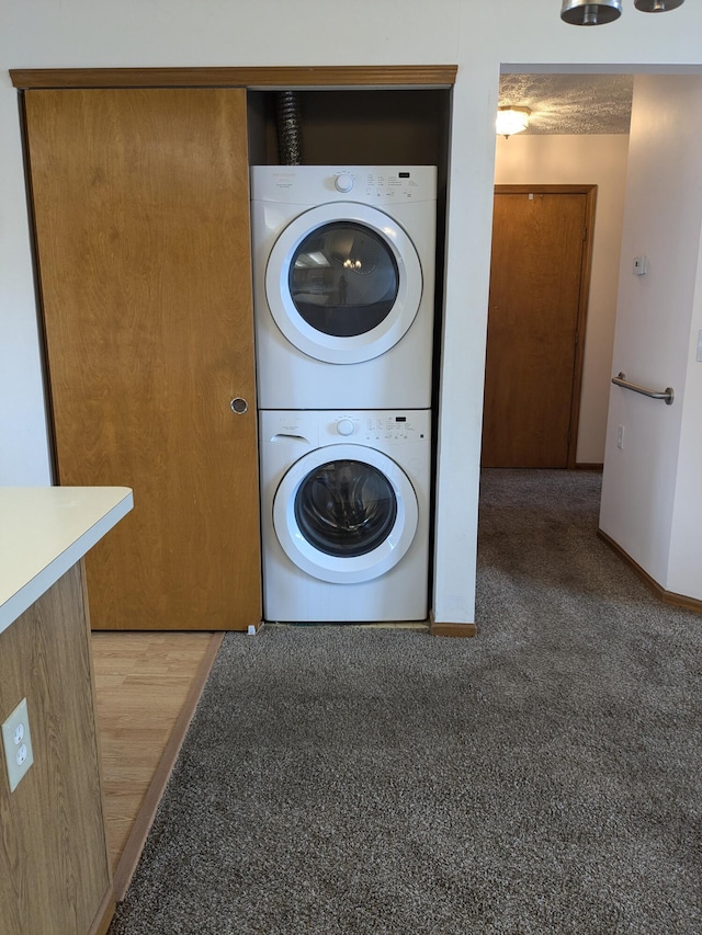 5813 Thada Ln, Columbus, OH 43229 - laundry room featuring stacked washing machine and dryer and light colored carpet