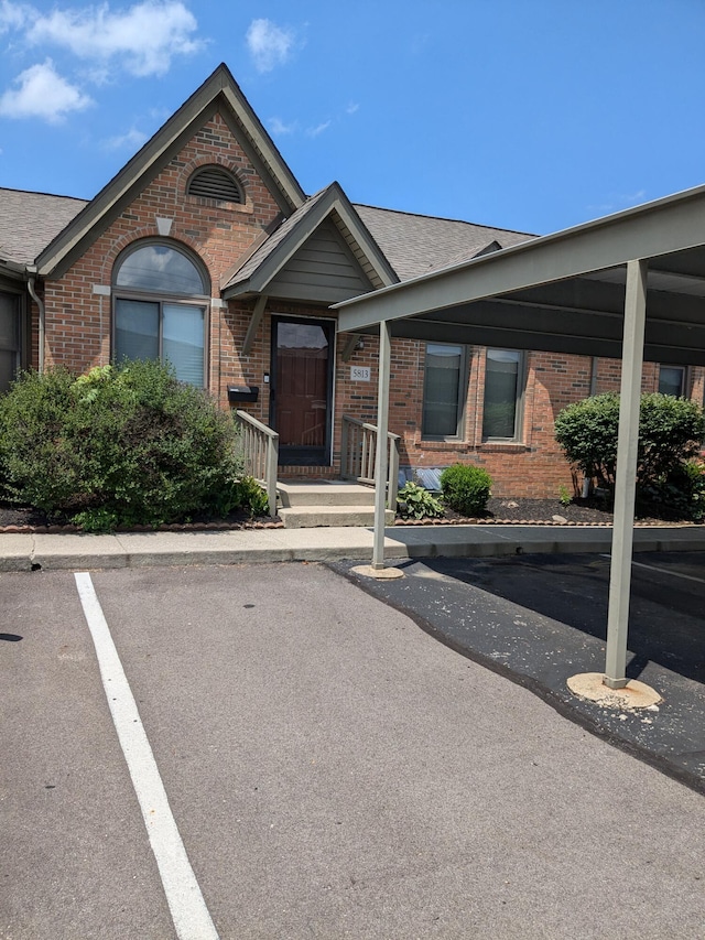 5813 Thada Ln, Columbus, OH 43229 - view of front of house with brick siding, covered parking, and a shingled roof