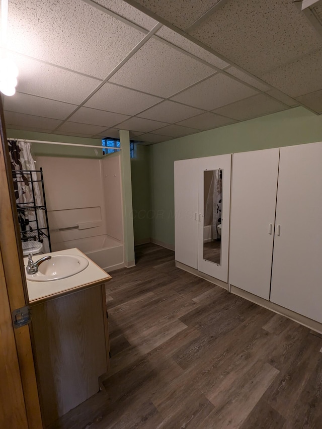 5813 Thada Ln, Columbus, OH 43229 - bathroom with a paneled ceiling, vanity, wood finished floors, and shower / tub combo