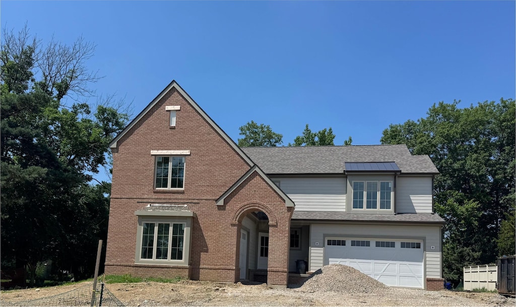 2450 Sandover Rd, Columbus, OH 43220 - english style home with brick siding, a garage, driveway, and roof with shingles