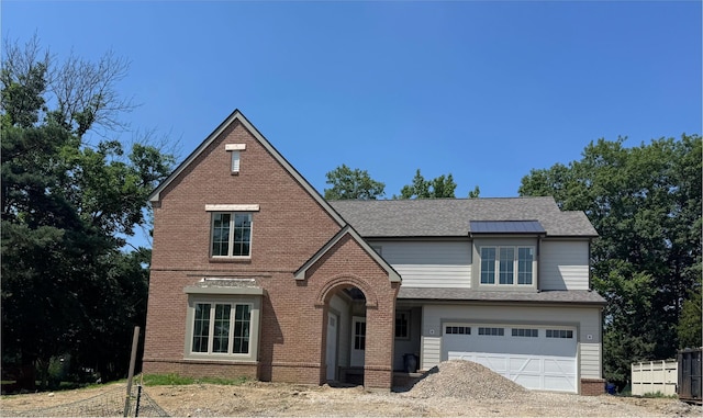 2450 Sandover Rd, Columbus, OH 43220 - english style home with brick siding, a garage, driveway, and roof with shingles