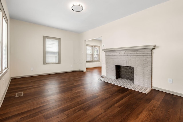 139 S Princeton Ave, Columbus, OH 43222 - unfurnished living room featuring dark wood-style flooring and a fireplace