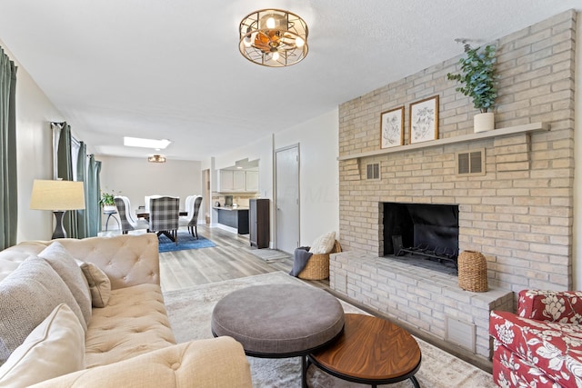 2635 Youngs Grove Rd, Columbus, OH 43231 - living area featuring light wood-type flooring and a brick fireplace