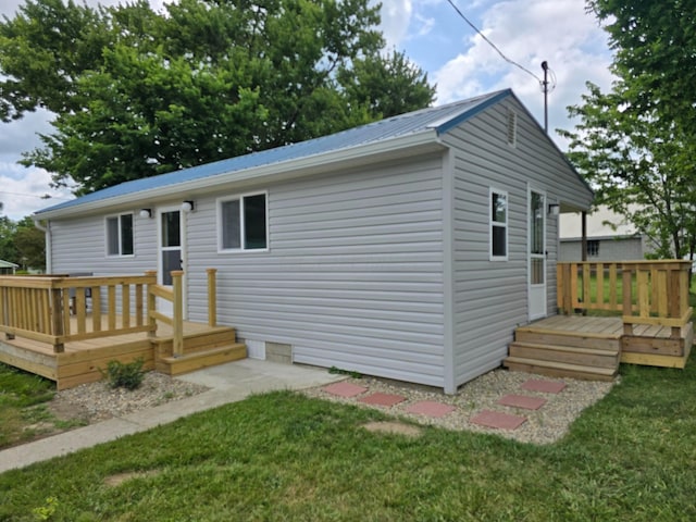 5369 Quincy St, Harpster, OH 43323 - rear view of property with a wooden deck, a metal roof, and a lawn
