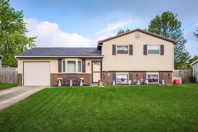 229 Danbury Rd, West Jefferson, OH 43162 - tri-level home featuring brick siding, asphalt driveway, a garage, and a shingled roof