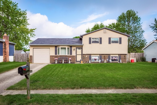 229 Danbury Rd, West Jefferson, OH 43162 - split level home featuring an attached garage, brick siding, and concrete driveway