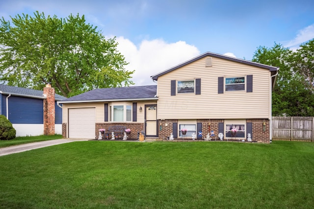 229 Danbury Rd, West Jefferson, OH 43162 - tri-level home featuring brick siding, concrete driveway, and an attached garage