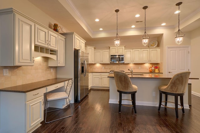 6918 Rothwell St, New Albany, OH 43054 - kitchen with appliances with stainless steel finishes, crown molding, dark countertops, a breakfast bar, and dark wood-style flooring
