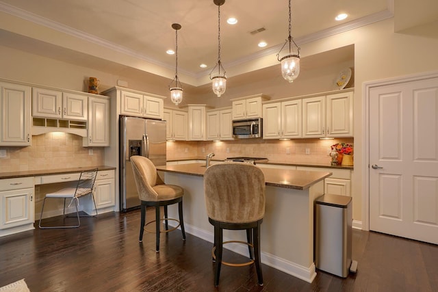 6918 Rothwell St, New Albany, OH 43054 - kitchen featuring stainless steel appliances, crown molding, tasteful backsplash, dark countertops, and a kitchen island with sink