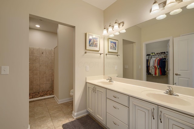 6918 Rothwell St, New Albany, OH 43054 - full bathroom featuring double vanity, tiled shower, tile patterned floors, and a walk in closet