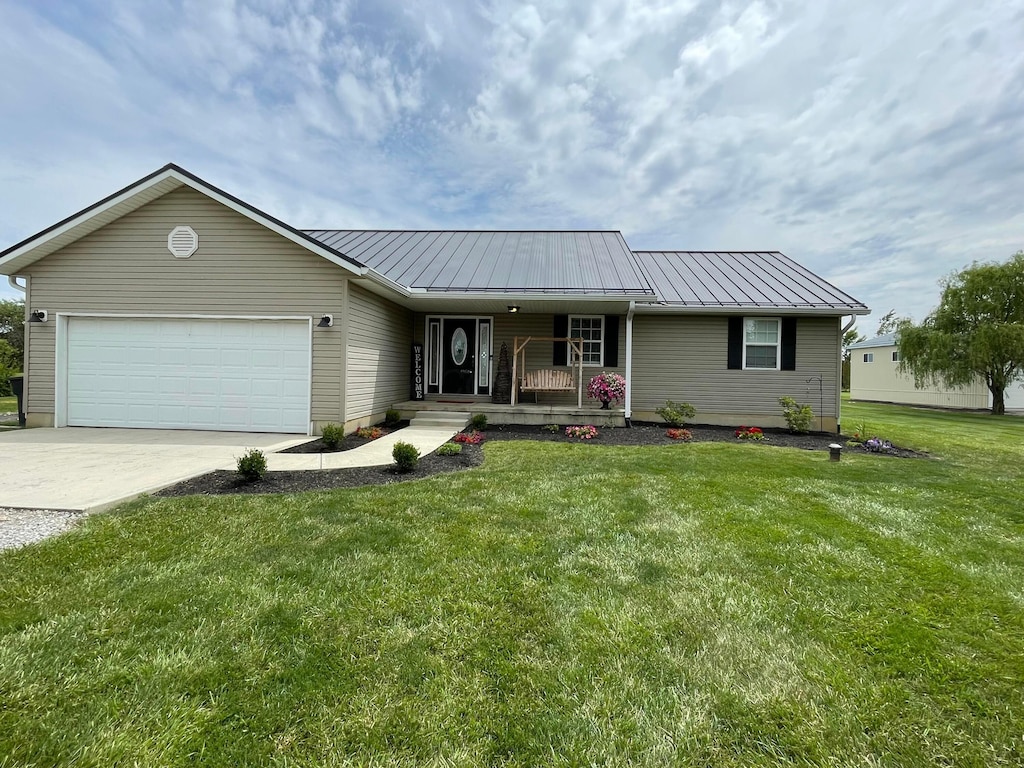 2767 W Old Duvall Ct, Lockbourne, OH 43137 - ranch-style house featuring covered porch, a standing seam roof, an attached garage, and a front yard