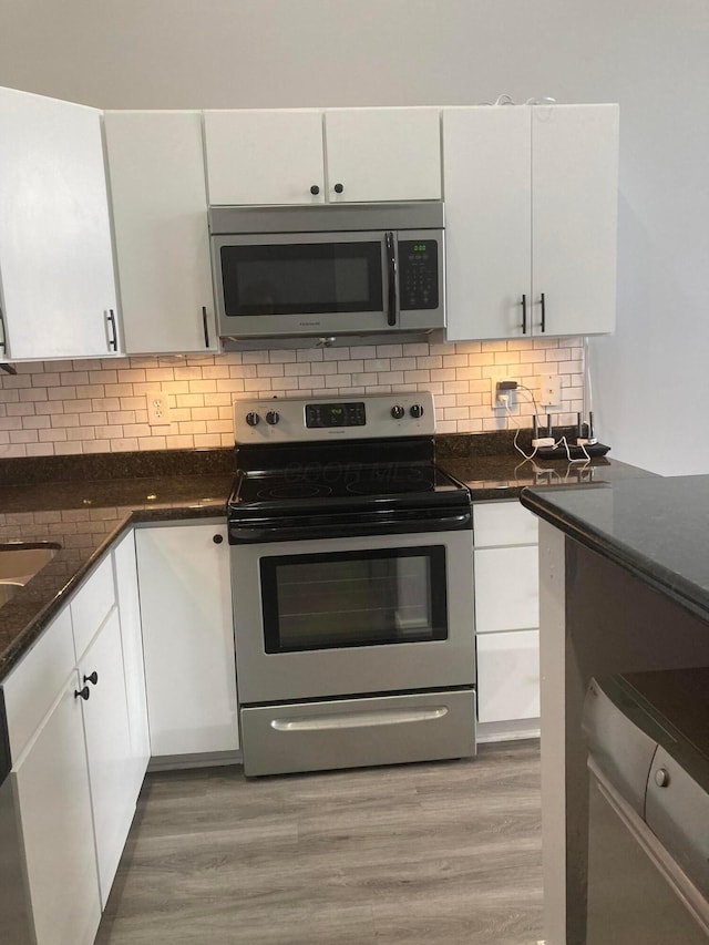 1276 N High St Unit 206, Columbus, OH 43201 - kitchen with appliances with stainless steel finishes, white cabinets, and decorative backsplash