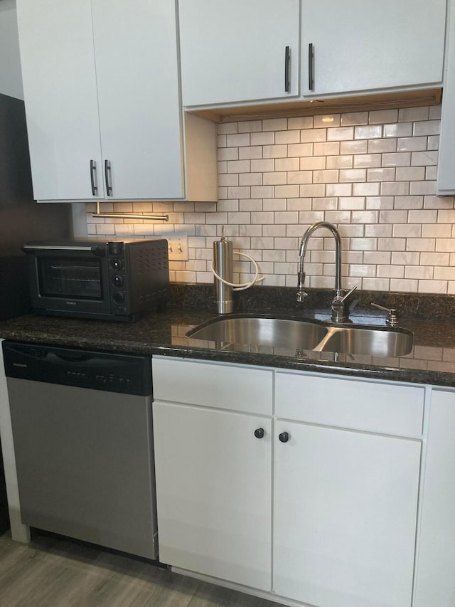 1276 N High St Unit 206, Columbus, OH 43201 - kitchen with stainless steel dishwasher, white cabinetry, dark stone counters, wood finished floors, and tasteful backsplash