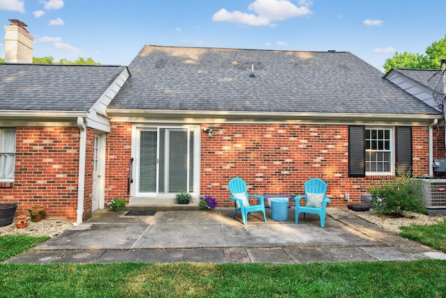 4368 Airendel Ct, Columbus, OH 43220 - rear view of property featuring brick siding, a patio area, and roof with shingles