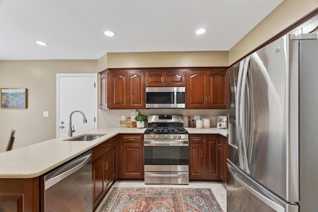 4368 Airendel Ct, Columbus, OH 43220 - kitchen featuring appliances with stainless steel finishes, light countertops, a peninsula, and recessed lighting