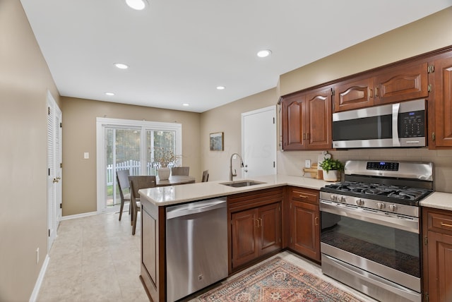 4368 Airendel Ct, Columbus, OH 43220 - kitchen with stainless steel appliances, light countertops, a peninsula, tasteful backsplash, and recessed lighting