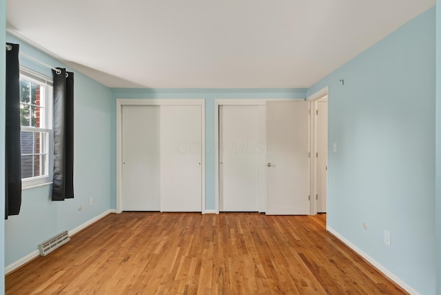 4368 Airendel Ct, Columbus, OH 43220 - unfurnished bedroom with two closets and light wood-style flooring