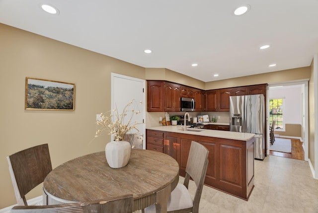 4368 Airendel Ct, Columbus, OH 43220 - kitchen with appliances with stainless steel finishes, light countertops, a peninsula, and recessed lighting