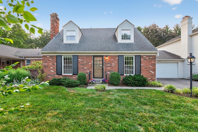 4368 Airendel Ct, Columbus, OH 43220 - cape cod house featuring brick siding, a front lawn, asphalt driveway, and roof with shingles