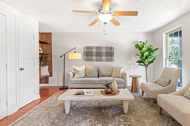 3155 El Greco Dr, Columbus, OH 43204 - living area with wood finished floors, a textured ceiling, and a ceiling fan