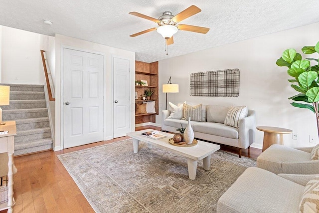 3155 El Greco Dr, Columbus, OH 43204 - living area featuring a textured ceiling, a ceiling fan, stairs, and light wood-style flooring