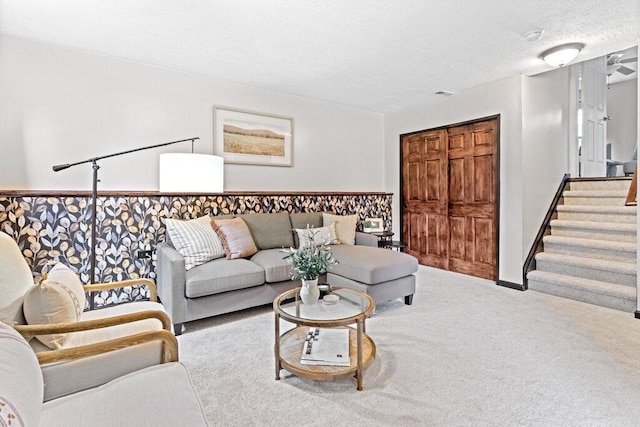 3155 El Greco Dr, Columbus, OH 43204 - carpeted living area with stairway and a textured ceiling
