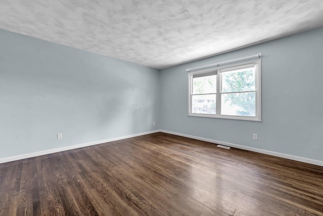 1293 Gresham Rd, Columbus, OH 43204 - spare room with dark wood-type flooring and a textured ceiling