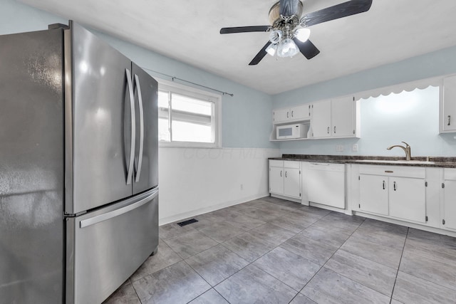 1293 Gresham Rd, Columbus, OH 43204 - kitchen featuring white appliances, white cabinetry, a ceiling fan, a wainscoted wall, and open shelves