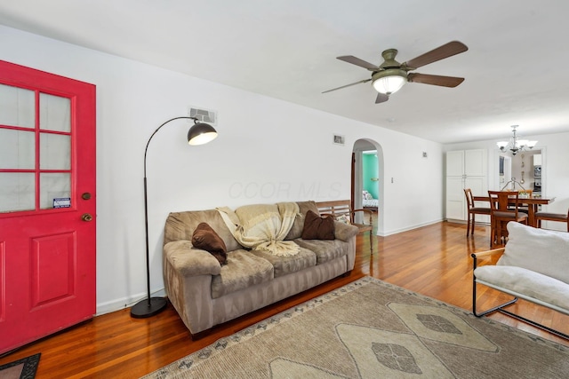 1317 Broadview Ave, Columbus, OH 43212 - living area with arched walkways, a ceiling fan, wood finished floors, and a chandelier