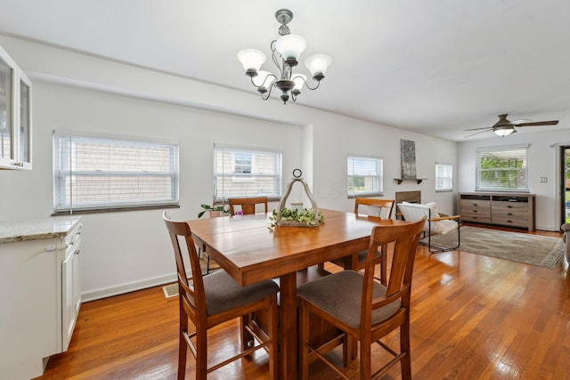 1317 Broadview Ave, Columbus, OH 43212 - dining space with light wood-style flooring, a chandelier, and ceiling fan