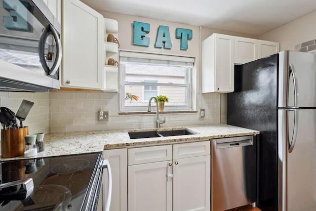 1317 Broadview Ave, Columbus, OH 43212 - kitchen with appliances with stainless steel finishes, white cabinetry, decorative backsplash, and light stone countertops