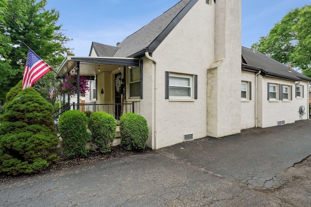 1317 Broadview Ave, Columbus, OH 43212 - view of side of property with stucco siding, roof with shingles, and a porch